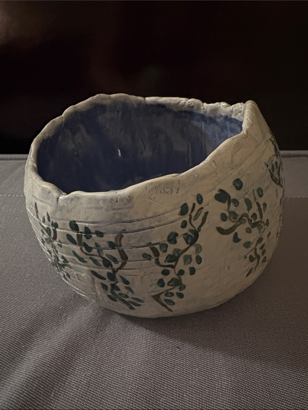 Handcrafted Off-White Ceramic Bowl with Blue Interior and Green Leaf Motif